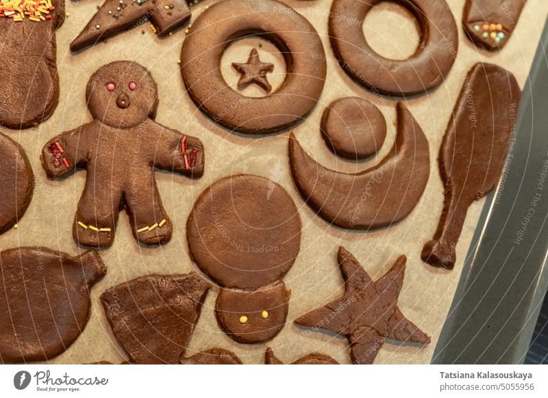 Top view of ginger Christmas cookies of different shapes and shapes on parchment gingerbread cookies sweets Cookie Sweet Food Dessert Baked Pastry Item