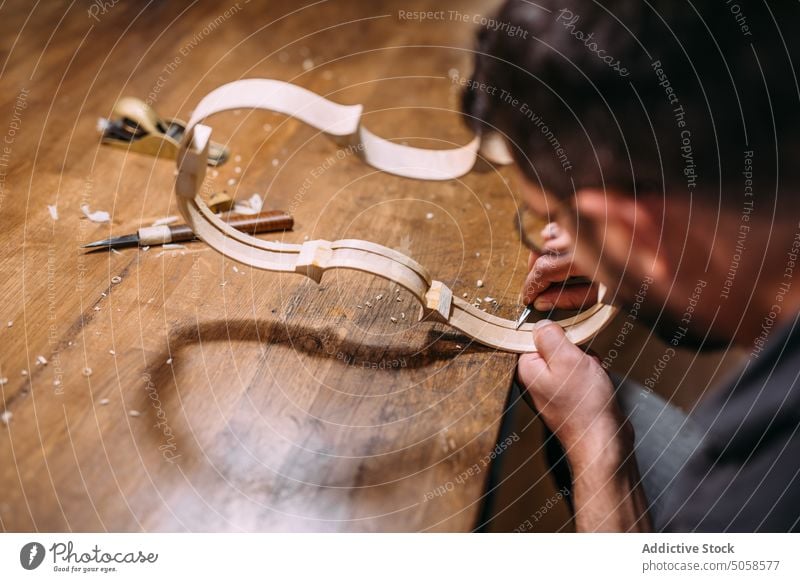 Anonymous luthier creating violin ribs in workshop craftsman artisan instrument professional workbench skill production handmade manual manufacture process