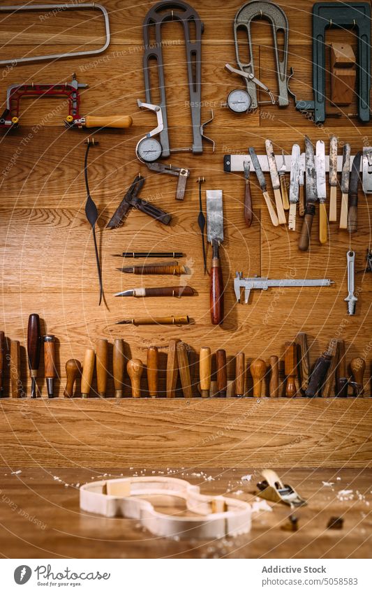 Workbench of luthier with unfinished violin and tools workshop table instrument workplace artisan craft luthiery woodwork manual maintenance collection detail