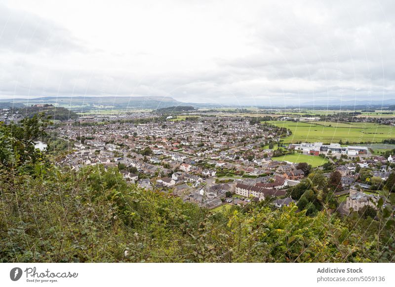 Aerial view of low rise town landscape cityscape scotland field meadow forest picturesque valley nature woods lawn cloudy grass green grassy tree environment