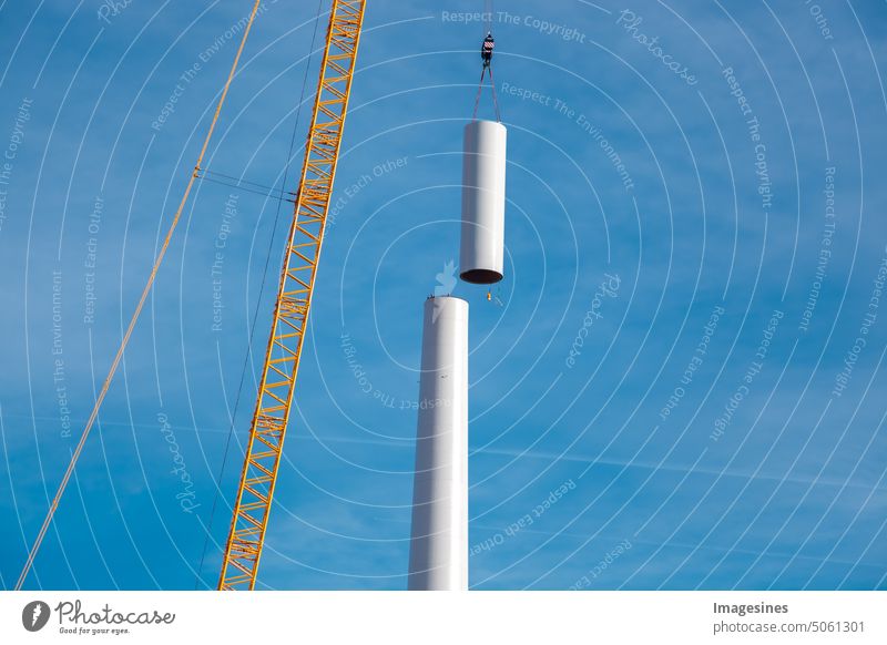 Erection and assembly of a wind turbine by crane. Construction work on the wind turbine at the Wörrstadt wind farm, Germany. Energy crisis concept, wind turbine construction