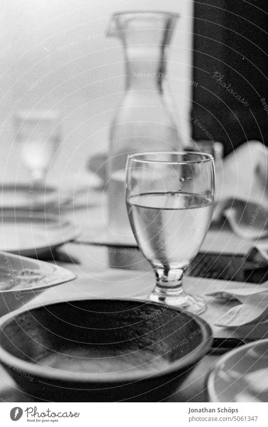 Still life dining table, glass of water, carafe, soup plate Film Isreal Grain Middle East Travel photography travel Summer South Analog Black & white photo