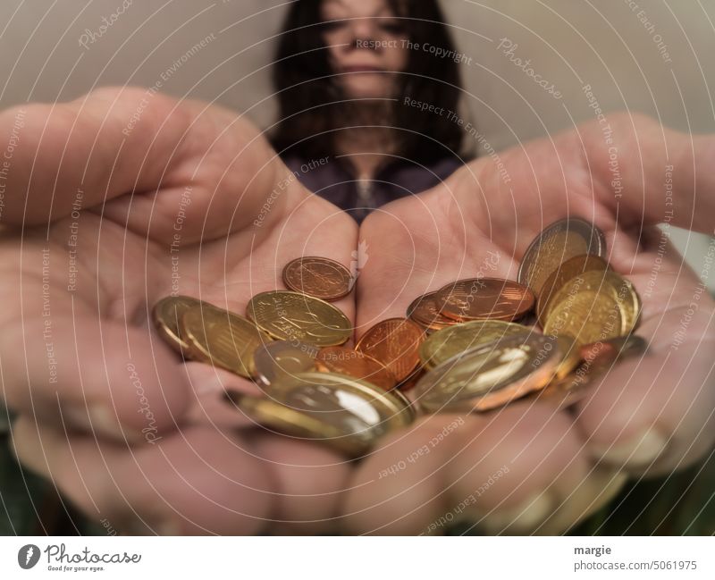 Small change. A woman shows coins with oversized hands Woman Hand Indicate Money Euro Coin Loose change Paying Save Coins small change Fingers Shopping Luxury