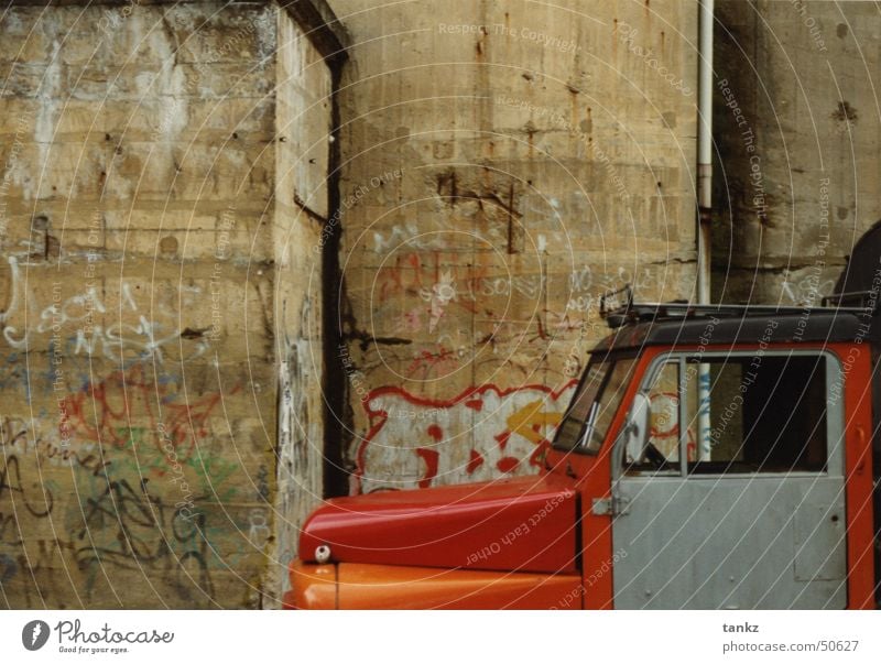 A furious standstill Wall (building) Cavernous Concrete Truck Car Hood Red Exterior shot Dugout Berlin Graffiti driver's cab Orange
