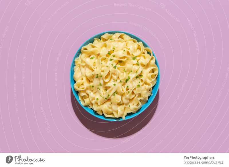 Pasta fettuccine alfredo above view on a purple background blue bright butter carbs cheese color comfort copy space cuisine delicious dinner dish flat lay food