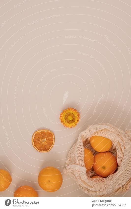 Pastel flat lay with mandarin oranges, reusable bag aesthetic winter winter aesthetic citrus citrus aesthetic winter self-care flatlay aesthetic flat lay beige