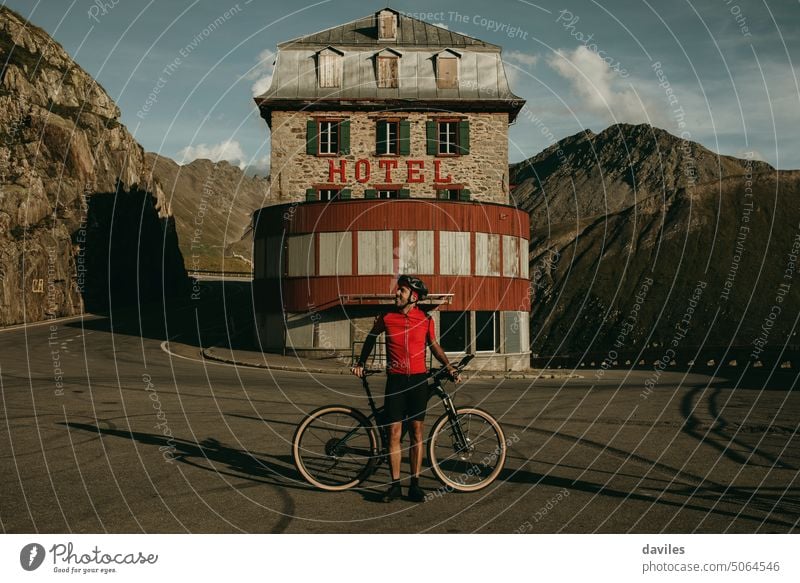 Cyclist portrait in the middle of a turn, at Furkapass Swiss Alps alpine alps architecture beard belvedere bicycle bikepacking bond curve cycling cyclist furka