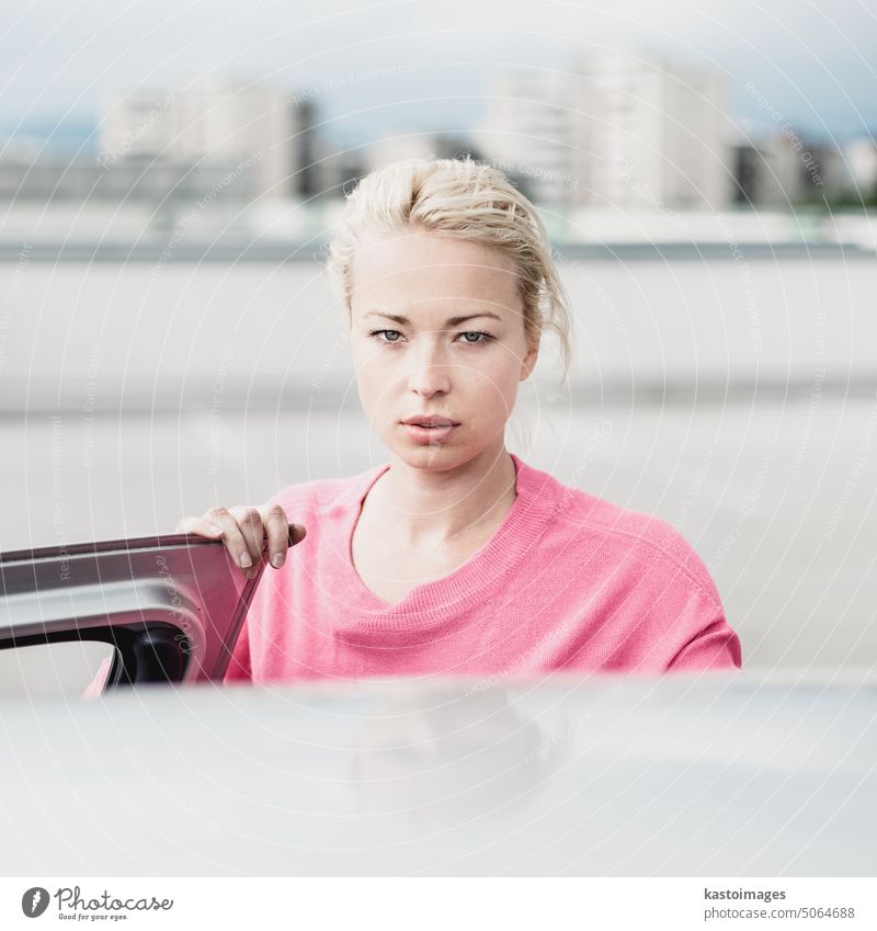 Portrait of responsible female driver holding car keys in her hand. Safe driving school woman license auto new exam excited driving license glass retail