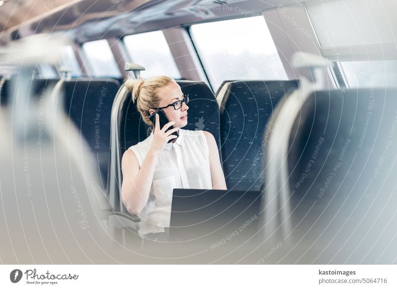 Business woman working while travelling by train. businesswoman talk phone laptop transport passenger railway journey transportation smart phone cell phone