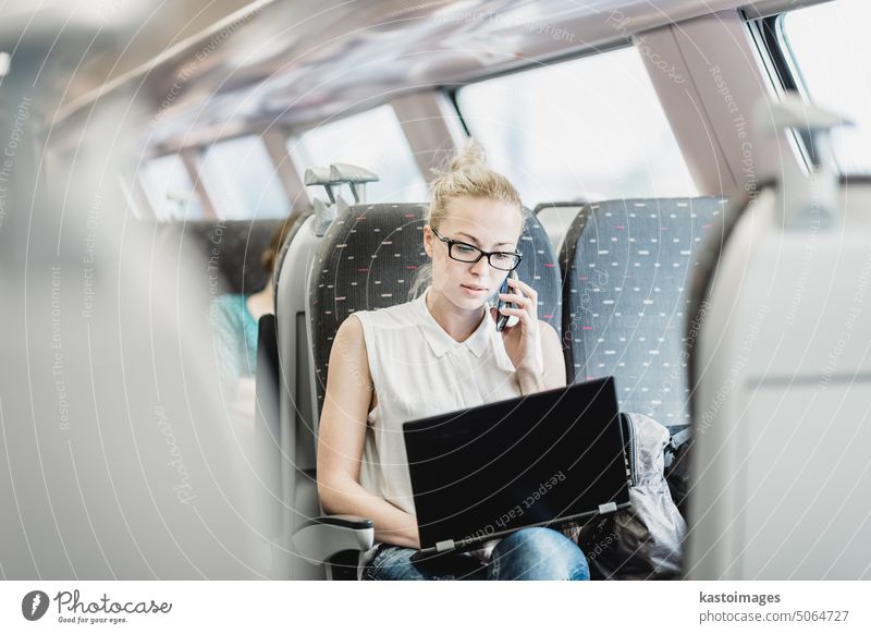 Business woman working while travelling by train. businesswoman talk phone laptop transport passenger railway journey transportation smart phone cell phone