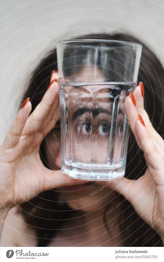 Woman looking through empty glass Photo idea pretty Face of a woman Artistic Looking Looking into the camera portrait Young woman Human being Adults Style