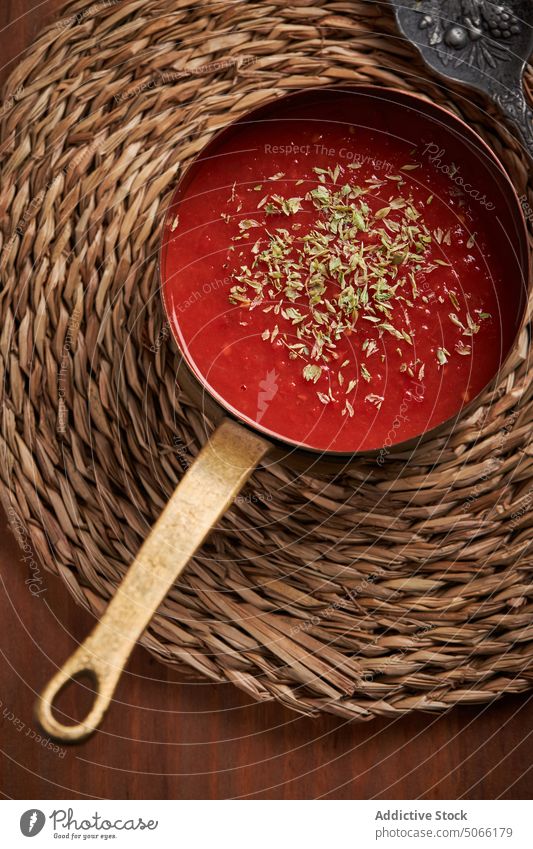 Saucepan with tomato sauce on woven mat saucepan serve dish herb food homemade culinary kitchen natural organic product fresh gastronomy nutrition portion
