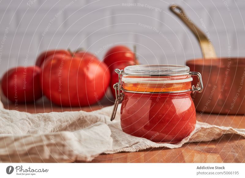 Glass jar with tomato sauce ingredient home kitchen culinary fresh glass food woven natural organic vegan tasty domestic diet nutrition composition homemade