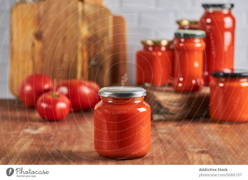 Sealed jar with fresh sauce tomato seal preserve table kitchen lid glass homemade food handmade cuisine tasty gastronomy delicious organic ingredient natural