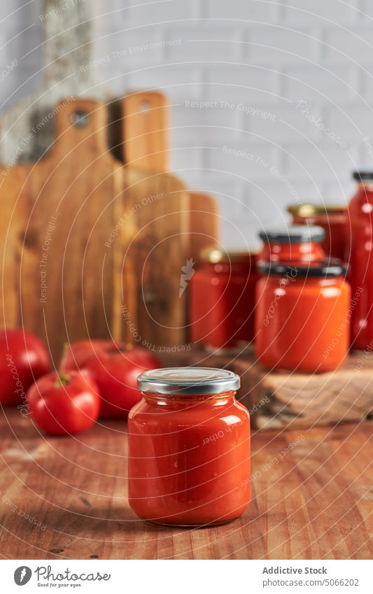 Sealed jar with fresh sauce tomato seal preserve table kitchen lid glass homemade food handmade cuisine tasty gastronomy delicious organic ingredient natural