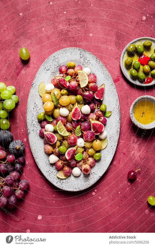 Grapes and olives salad kitchen vegetarian table cheese recipe grapes mozzarella leaves fresh ingredients food meal cuisine healthy seasoning savory nutrition