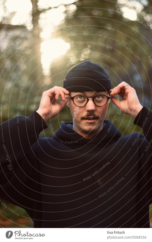 CHECK AGAIN... Man Eyeglasses Cap mustache Facial hair Face Adults Exterior shot Colour photo look up put on glasses Optician hoodie Leisure and hobbies Life