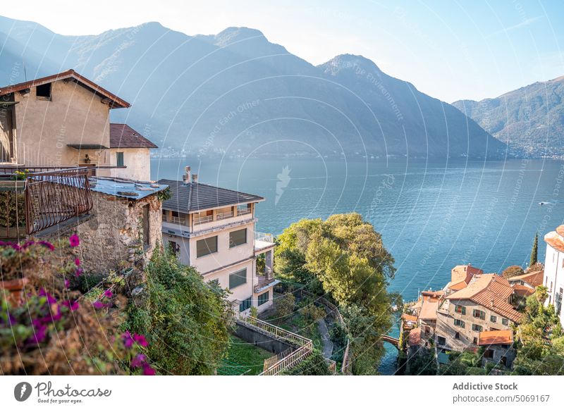 Houses on shore of picturesque lake town mountain architecture building city hill landscape aged nature scenic coast house italy exterior summer environment