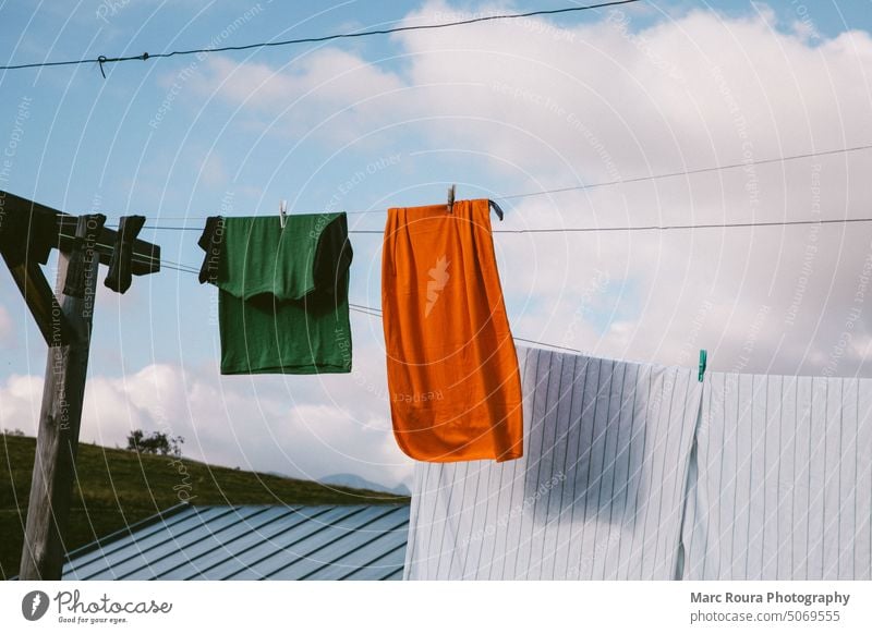 https://www.photocase.com/photos/5069555-clothes-drying-on-a-clothesline-baby-background-photocase-stock-photo-large.jpeg
