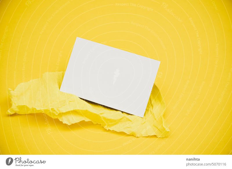 Blank business card over a yellow crepe paper against yellow background mockup blank flatlay minimal minimalistic fashion colorful intense monochrome elegant