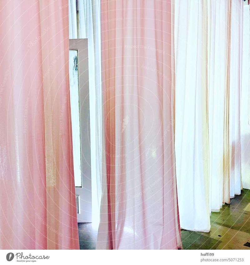 pink and white illuminated curtains of a dressing room fitting room with slightly opened mysitrious window sash Drape Pink White Illuminated Curtain Cloth Light
