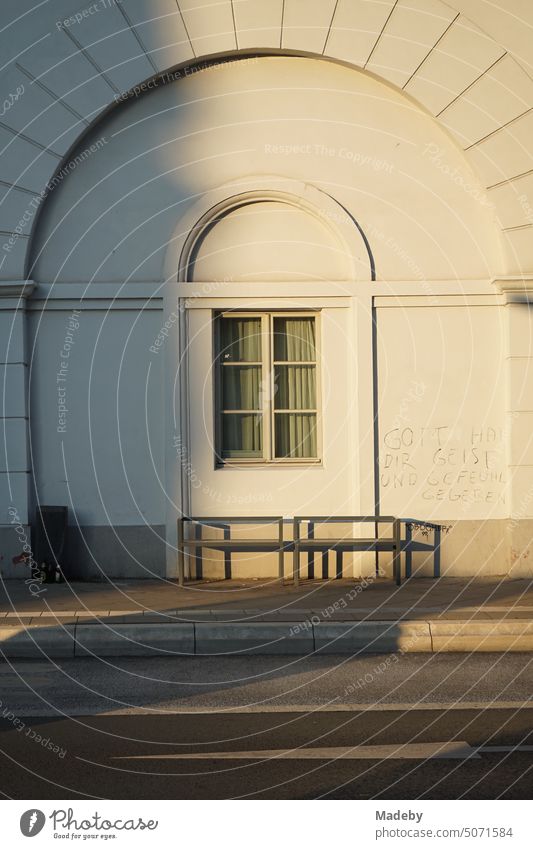 Old white building with round arch and muntin windows in the light of the evening sun at Affentorplatz in the district Sachsenhausen in Frankfurt am Main in Hesse