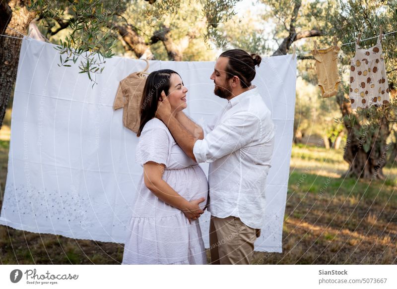 Happy young couple expecting baby. Pregnancy and parenthood concept. woman pregnant pregnancy photography outdoor happy Caucasian family motherhood maternity