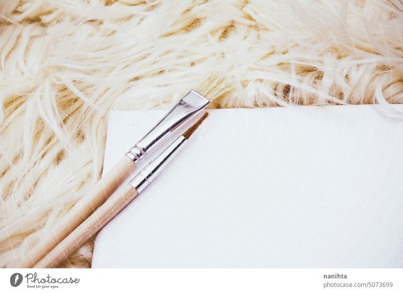 Simple and minimal mockup flat lay in neutral tones with canvas and brushes background texture art frame white brown beige artist soft cozy textile many new