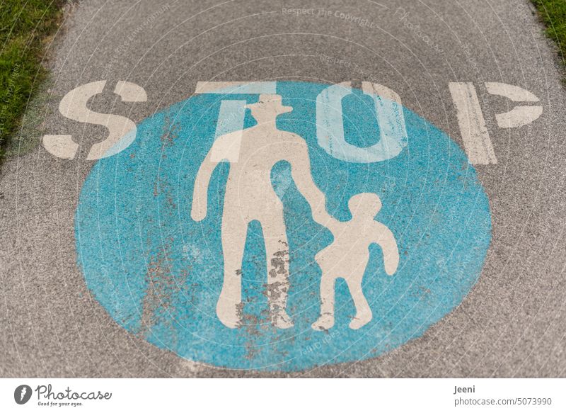 "STOP" when the child pulls the man with hat Child Human being Signs and labeling mark Text Pictogram stop Stop Word Hold Street Transport Lanes & trails