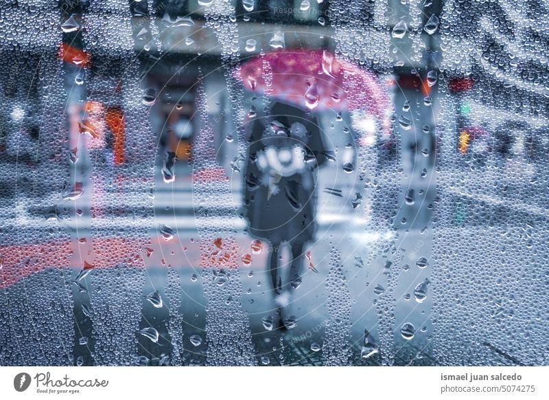 pedestrian with an umbrella in rainy days in Bilbao city, spain people person raining rainy season water drops street urban bilbao basque country walking