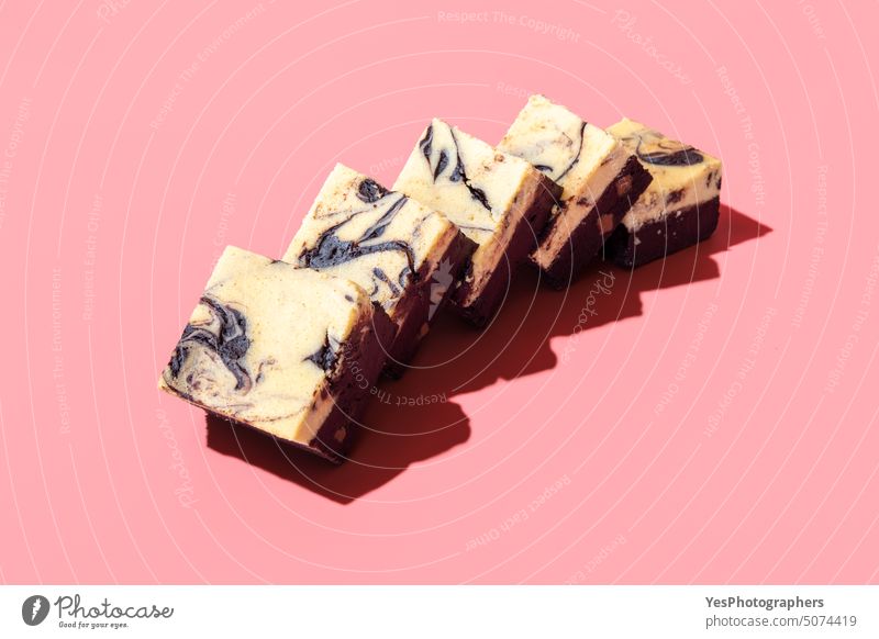 Cheesecake brownie slices isolated on a pink background bakery birthday black bright cheese cheesecake chocolate close-up cocoa color confectionery copy space