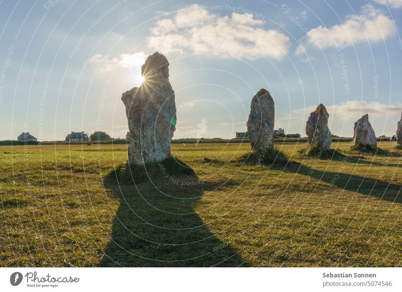 Alignment of menhir stones during golden hour with sun on the sky, Camaret-sur-Mer, Brittany, France prehistoric brittany travel alignment ancient france