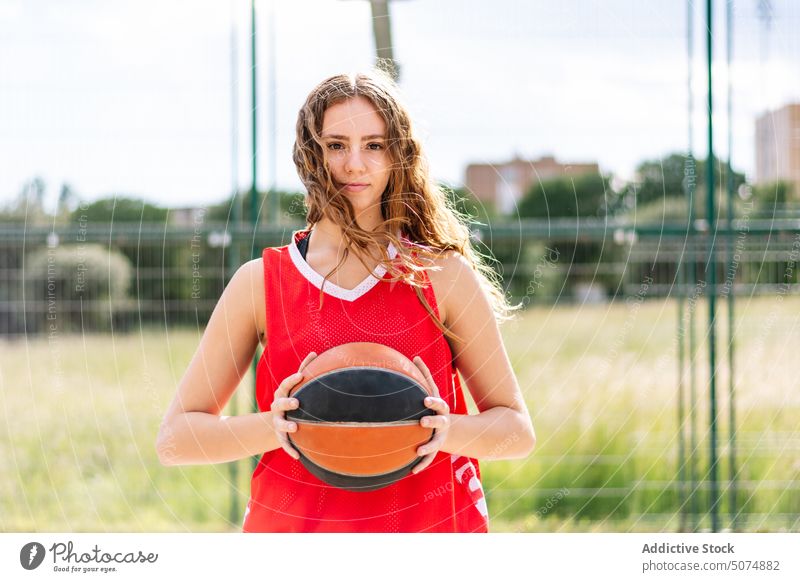 Female basketball player with ball on sports ground sportswoman streetball hoop goal game female sky summer hobby practice training activity lifestyle fit