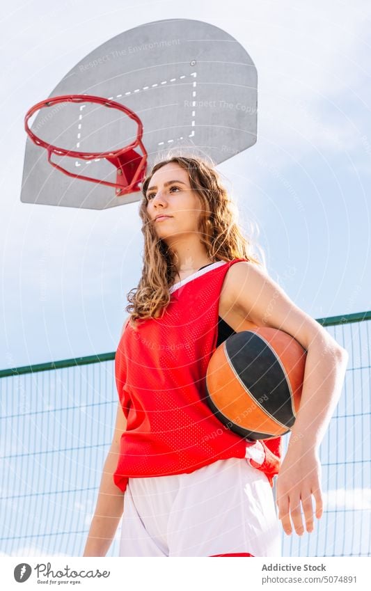 Female basketball player with ball on sports ground sportswoman streetball hoop portrait goal game female sky summer hobby practice training activity lifestyle