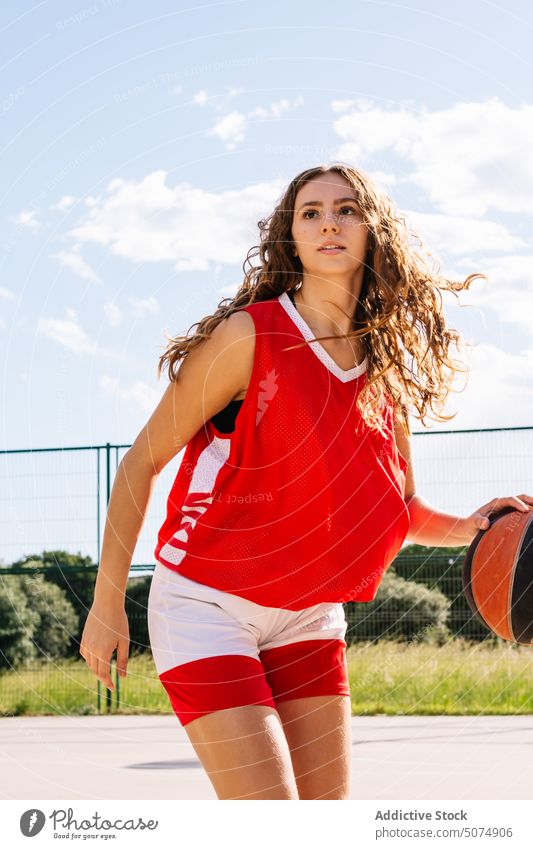 Caucasian woman playing street basketball on court young streetball player game sports ground female caucasian activity determine summer sportsman energy