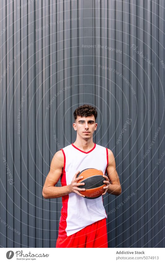 Male basketball player with ball against dark background portrait sportsman streetball hold sports ground goal game male hobby practice training activity