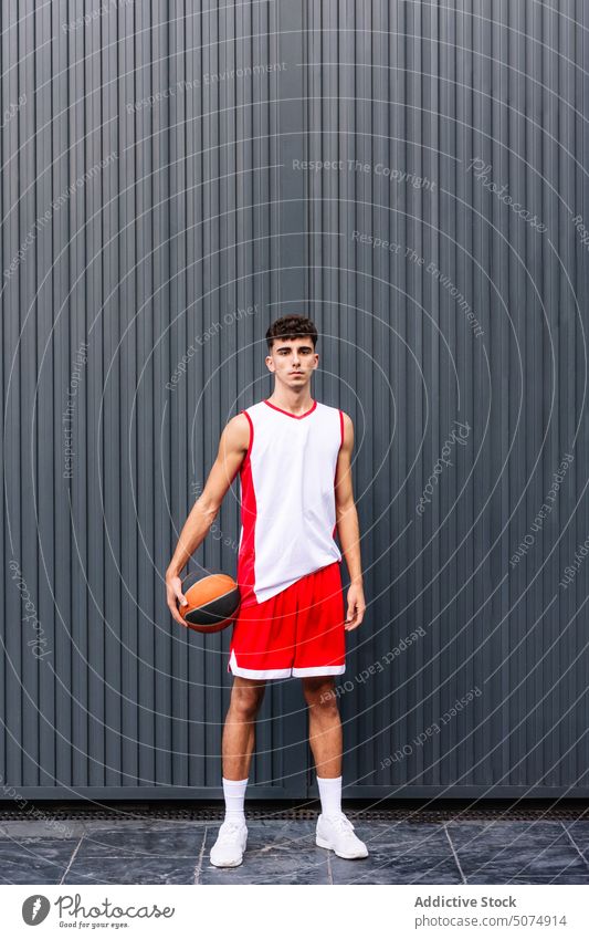 Male basketball player with ball against dark background portrait sportsman streetball hold sports ground goal game male hobby practice training activity