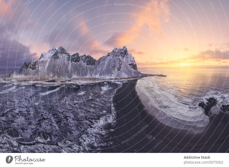 Amazing view of mountain in sea at sunset landscape seascape scenic picturesque Stockness beach Iceland Vestrahorn frozen snow nature rocky winter endless calm