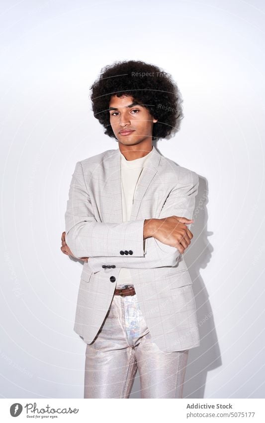 Hispanic man looking at camera style appearance suit model male young hispanic ethnic personality individuality accessory jacket curly hair afro charismatic