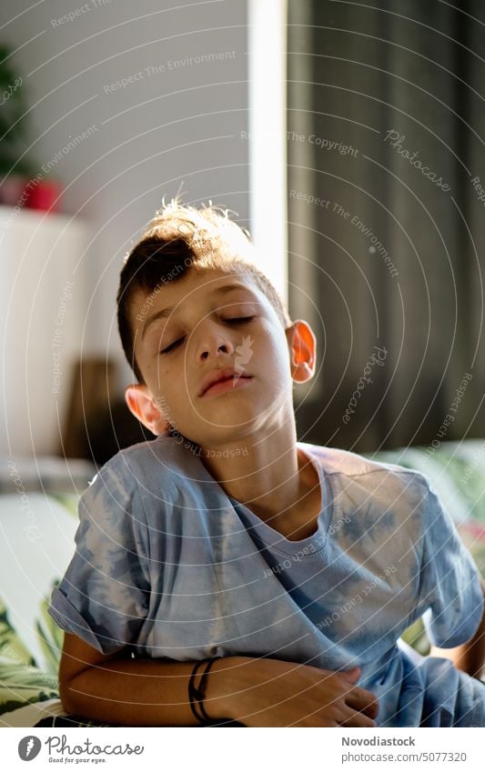 Portrait of a 9 year old boy with his eyes closed, at home Boy (child) Caucasian Portrait photograph Child one boy only Cute relaxed indoors natural light kid