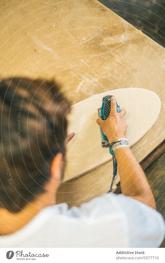 Male worker sanding wood in industry man carpenter polish sander plank board accuracy precise workshop woodworker wooden joinery carpentry male electric