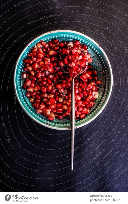 Ripe organic pomegranate fruit seeds agriculture background ceramic concept dessert diet eat food half healthy modern napkin nature piece plate red ripe table