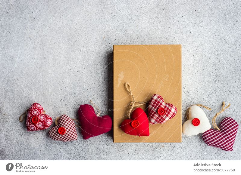 Rustic gift box with textile hearts valentine day background card concrete background engagement feeling festive from heart shaped holiday letter love message