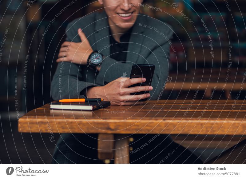Focused man using smartphone in cafe chat notebook rest cafeteria plan surfing internet focus businessman formal classy message browsing social media wireless