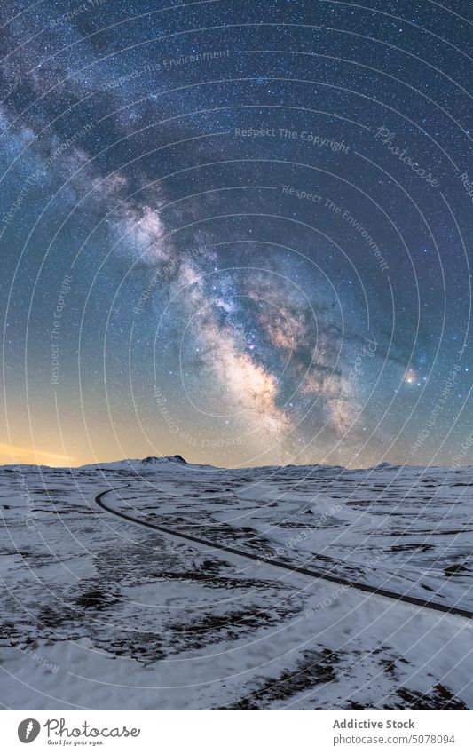 Long asphalt road surrounded with snow and ice at night in Iceland iceland vatnajokull national park frost galaxy sparkle endless narrow nature cold direction