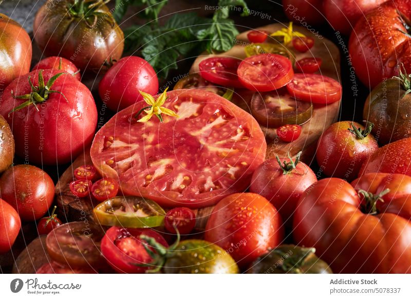 Fresh red ripe sliced tomatoes vegetable fresh food water healthy food nutrition natural organic vitamin tasty ingredient delicious drop kitchen chopping board