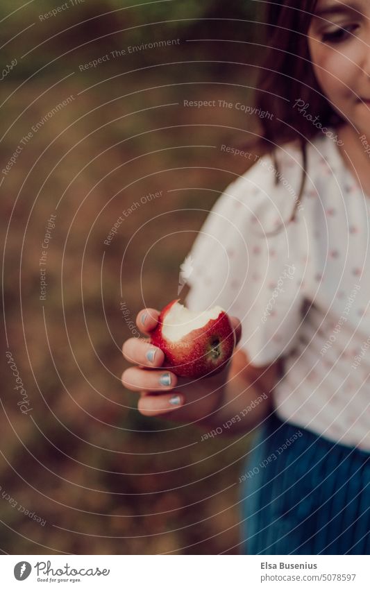 Child holding apple in hand Apple Hand Fingers out Playing Autumn Exterior shot Colour photo Infancy Nature Human being Joy Garden Happiness Girl discover