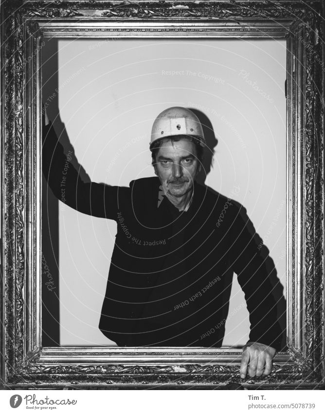 Man with construction worker helmet in picture frame Berlin lars Town Helmet Picture frame Construction worker b/w