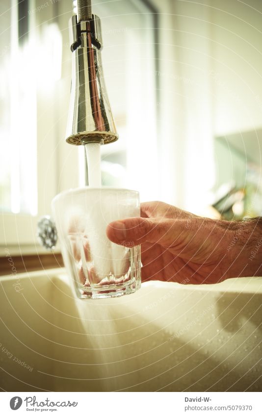 fill a glass with water on tap Drinking water Water Tap Glass Thirst Waste of water water consumption Hand fill in Fill