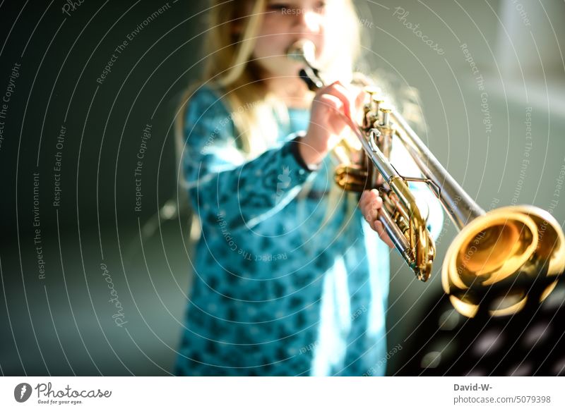Child plays a musical instrument Musical instrument Make music Girl Trumpet Musician Practice Leisure and hobbies Playing Culture Parenting Diligent Ambitious